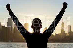 Woman Celebrating Arms Raised at Sunrise in New York City