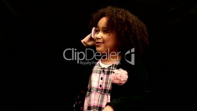 Young black girl/child with curly hair talking on mobile phone against black background 4