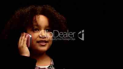 Young black girl/child with curly hair talking on mobile phone against black background 1