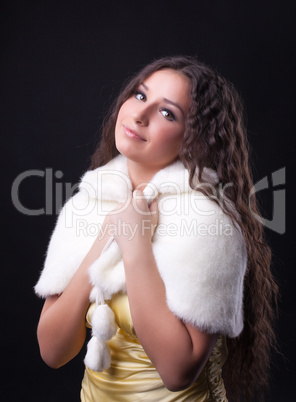 Young pretty girl close-up portrait in fur coat