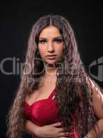 Young amazing girl with curly hair in red