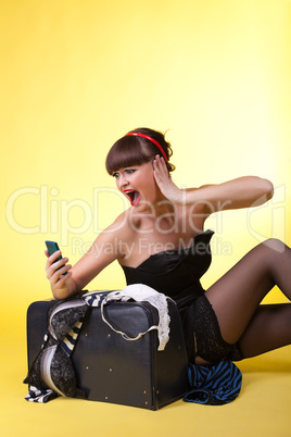 Young woman with broken baggage scream on cell