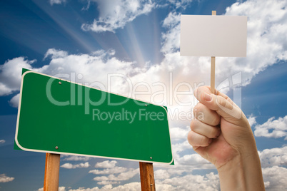Blank Green Road Sign and Man Holding Poster on Stick