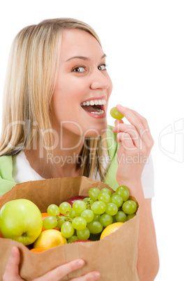 Healthy lifestyle - woman with fruit shopping paper bag