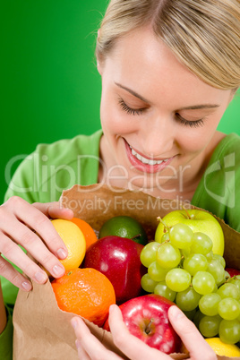 Healthy lifestyle - woman with fruit shopping paper bag