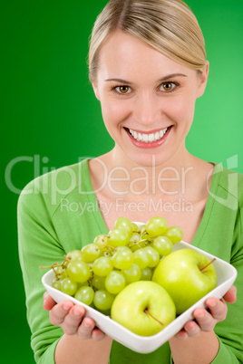 Healthy lifestyle - woman holding bowl with green fruit