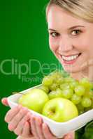 Healthy lifestyle - woman holding bowl with green fruit