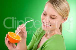 Healthy lifestyle - woman drink juice from orange