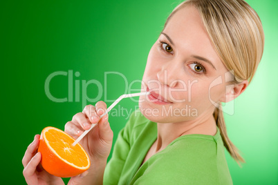 Healthy lifestyle - woman drink juice from orange