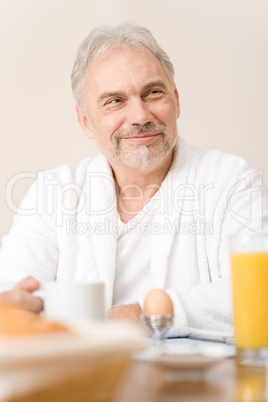 Senior mature man - breakfast at home