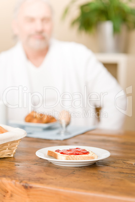 Senior mature man - breakfast at home