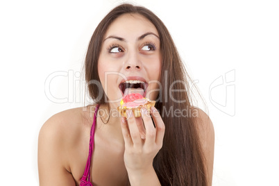 Pretty girl eating cream cake isolated on white