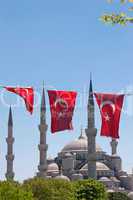 Mosque behind turkish flags