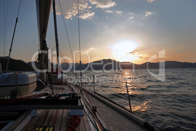 Sailing boat in the sea at sunset