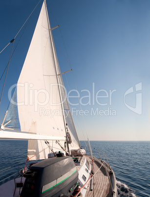 Yacht sailing in the sea, clear blue sky