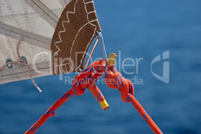 red rope, knot and piece of sail