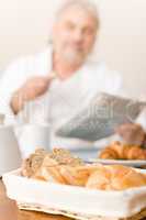 Senior mature man - breakfast pastry and bread