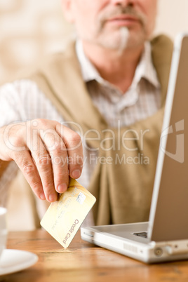 Senior mature man - home shopping with credit card