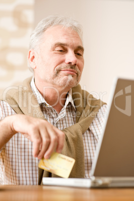 Senior mature man - home shopping with credit card