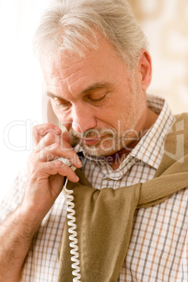 Thoughtful senior mature man call on phone