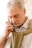 Thoughtful senior mature man call on phone