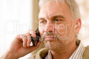 Thoughtful senior mature man call on mobile phone