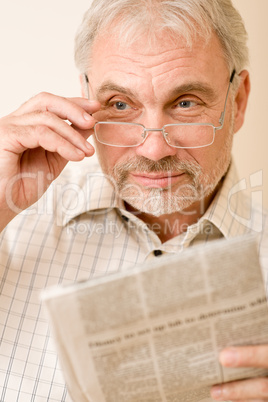 Senior mature man with glasses and newspaper