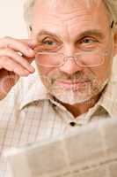 Senior mature man with glasses and newspaper
