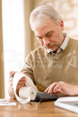 Senior mature man - home office with calculator