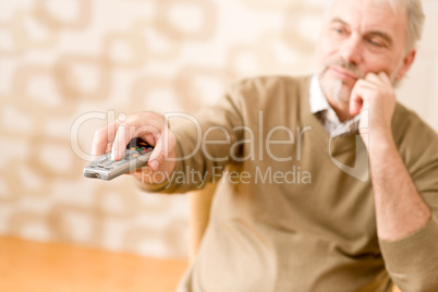 Senior mature man with remote control