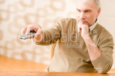 Senior mature man with remote control