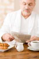 Senior mature man having breakfast