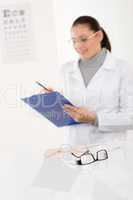 Optician doctor woman with glasses and eye chart