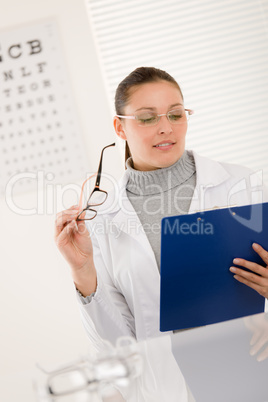 Optician doctor woman with glasses and eye chart