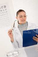 Optician doctor woman with glasses and eye chart