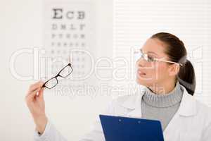 Optician doctor woman with glasses and eye chart