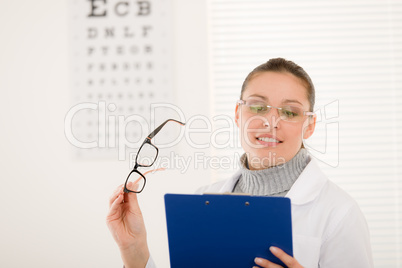 Optician doctor woman with glasses and eye chart