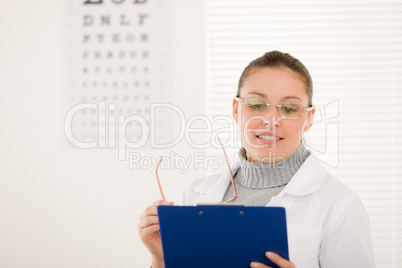 Optician doctor woman with glasses and eye chart