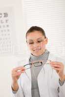 Optician doctor woman with glasses and eye chart