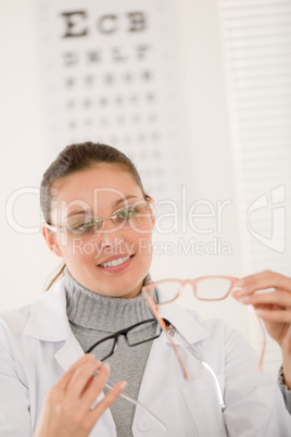 Optician doctor woman with glasses and eye chart