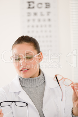 Optician doctor woman with glasses and eye chart