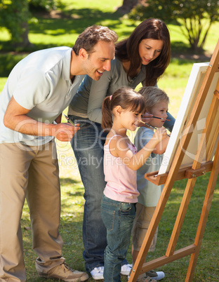 Family painting together in the park