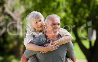 Man giving wife a piggyback