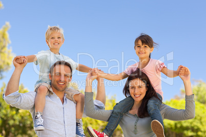 Parents giving  children a piggyback