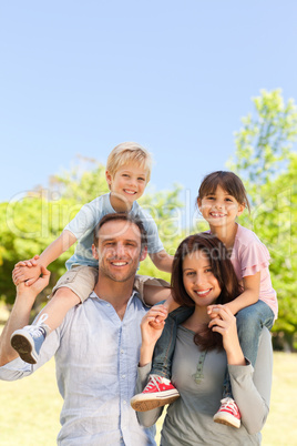 Parents giving  children a piggyback