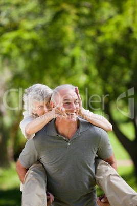 Man giving wife a piggyback