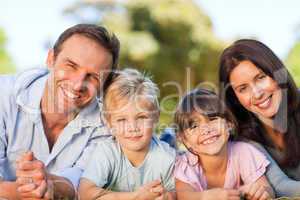 Family lying down in the park