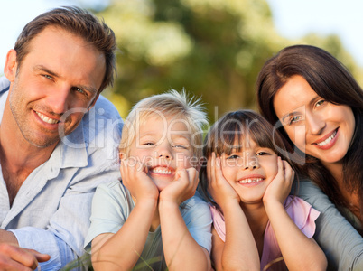 Smiling family picnicking in the park