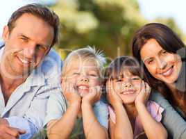 Smiling family picnicking in the park