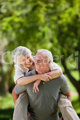 Man giving wife a piggyback